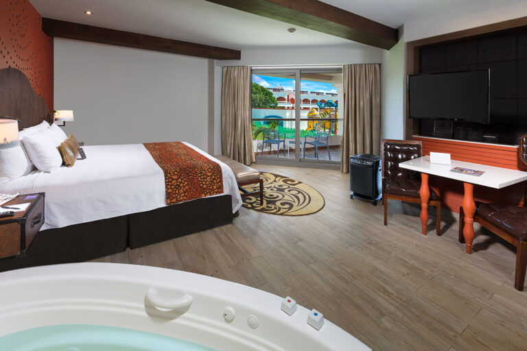 A single bed Deluxe Gold bedroom with balcony view of the resort.