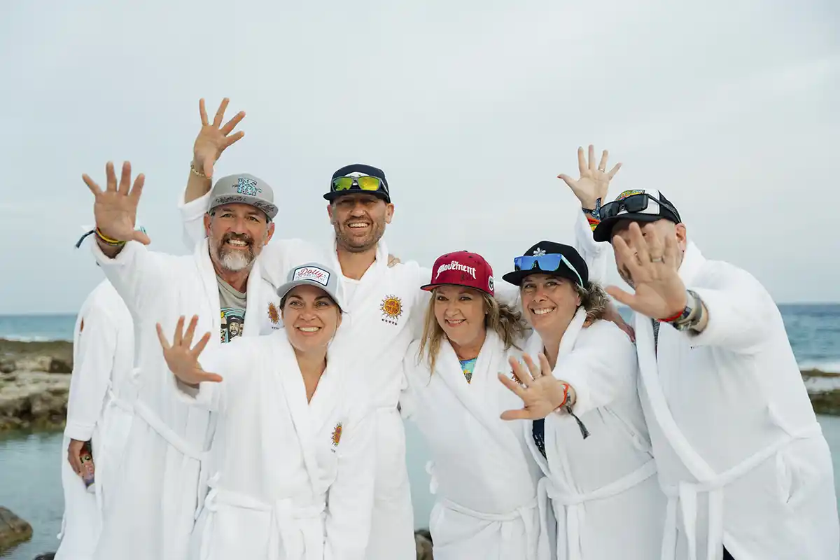 Group photo of guests wearing their loyalty gift white robes.