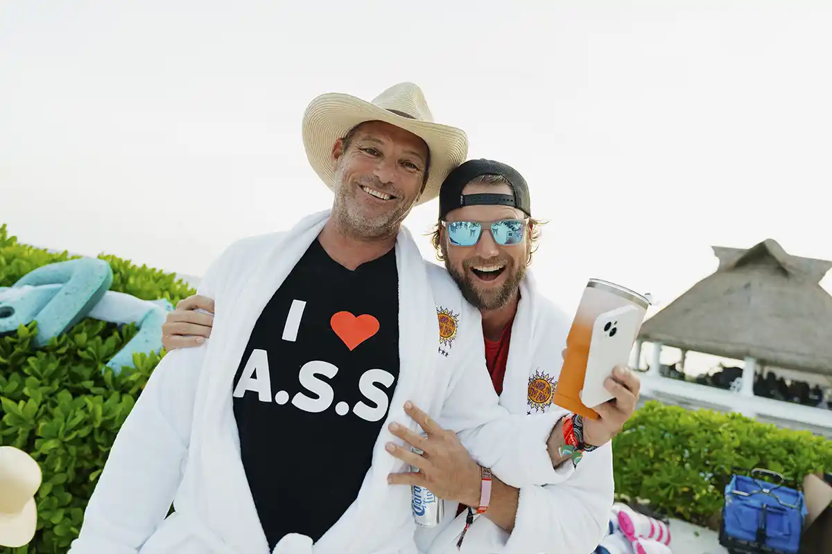 Guests posing in white robes given as a loyalty gift.