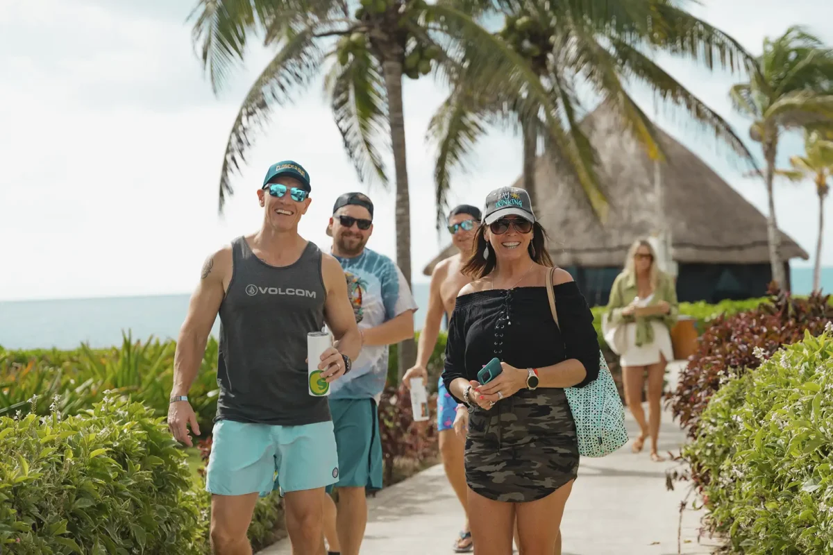 Group photo of guests walking along a beach path.