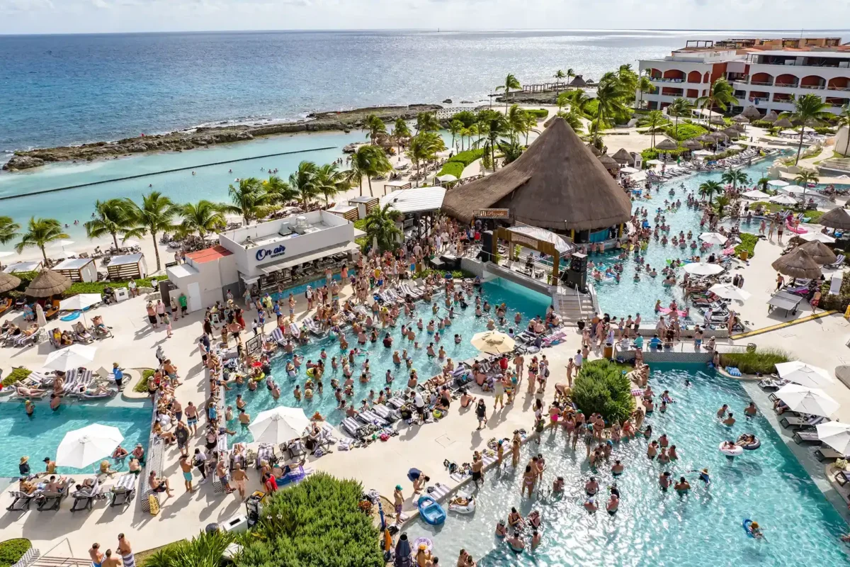 An aerial view of a poolside daytime concert.