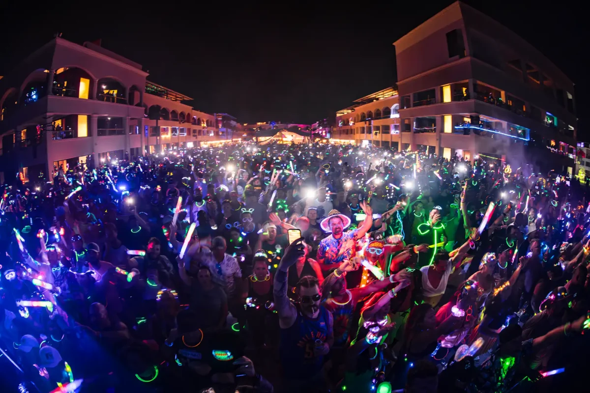 Photo of the Main Stage crowd holding neon lights for a "Light It Up" theme night.