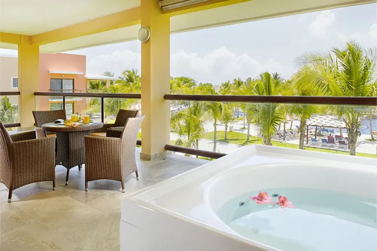 Balcony with lounge chairs and jacuzzi overlooking the resort.