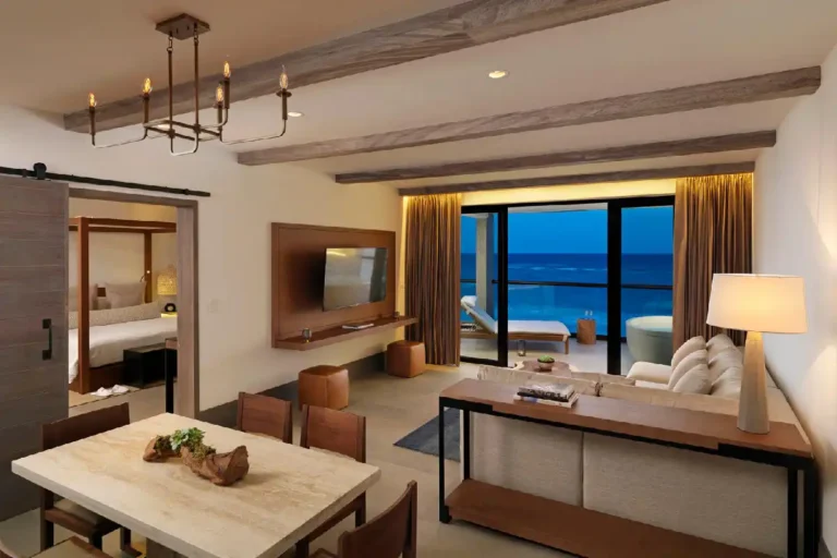 The living room area of an Estancia Suite with an ocean view balcony.