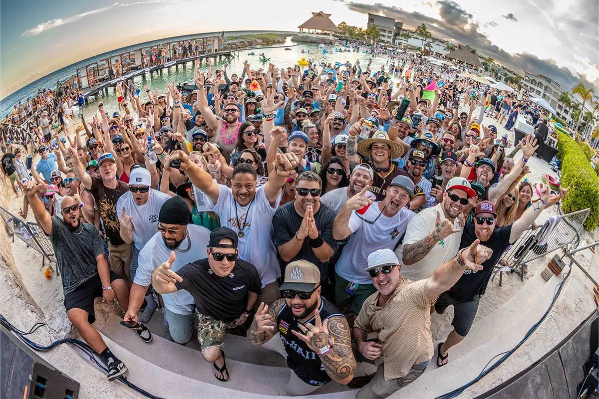 A group photo in the Beach Stage lagoon featuring all the members of Slightly Stoopid.