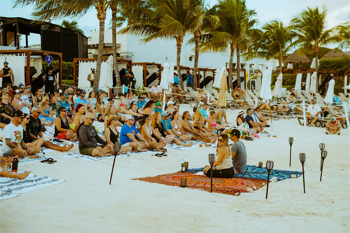 Guests meditating on the beach during an Intention Setting Ceremony at the start of the event.
