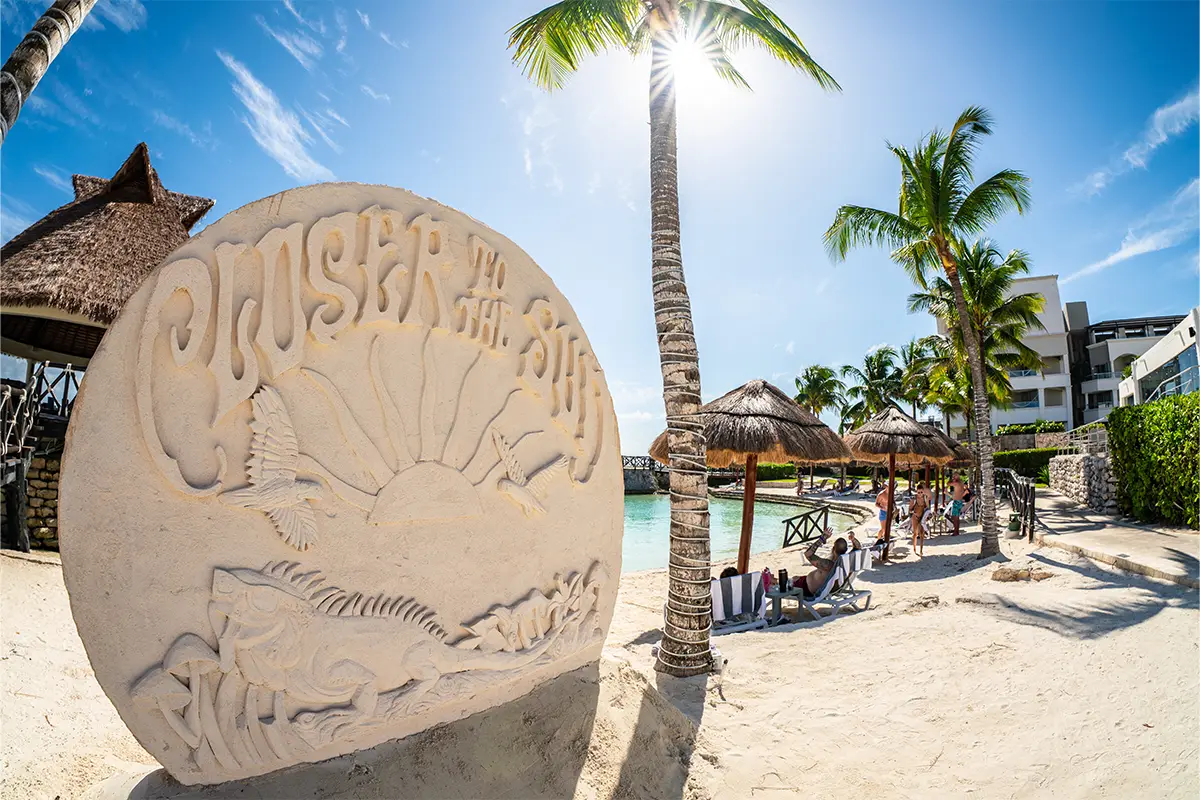 A sand sculpture with the Closer To The Sun logo.